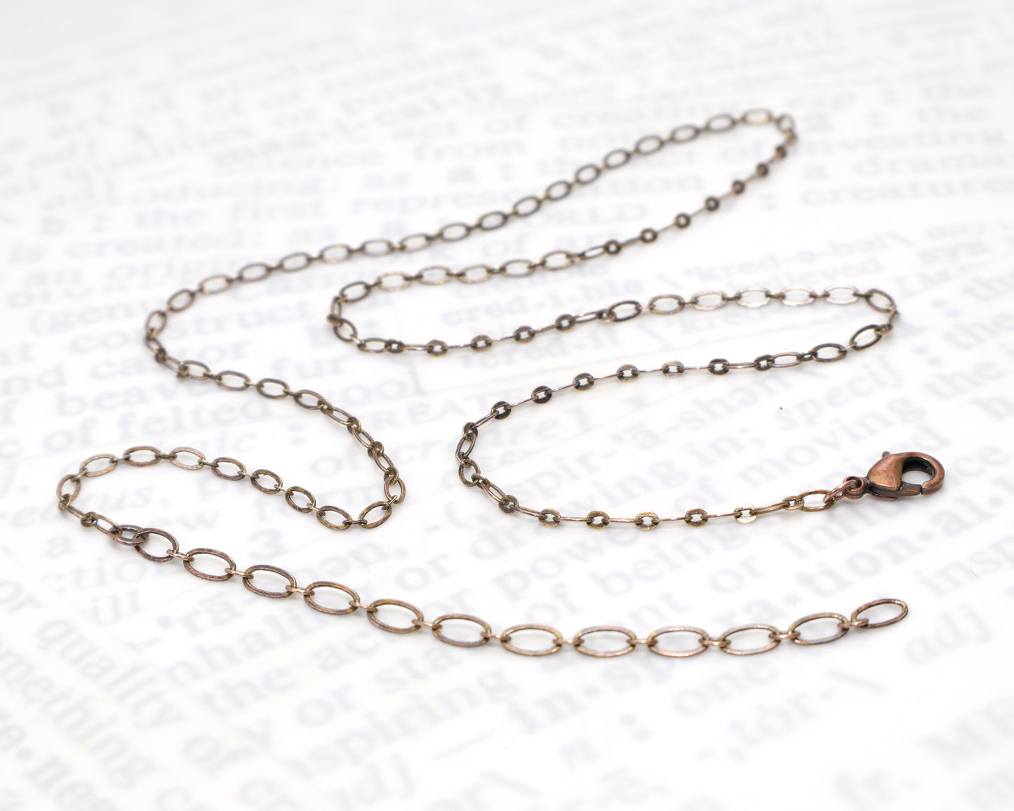 Adjustable oxidized copper chain with soldered links.