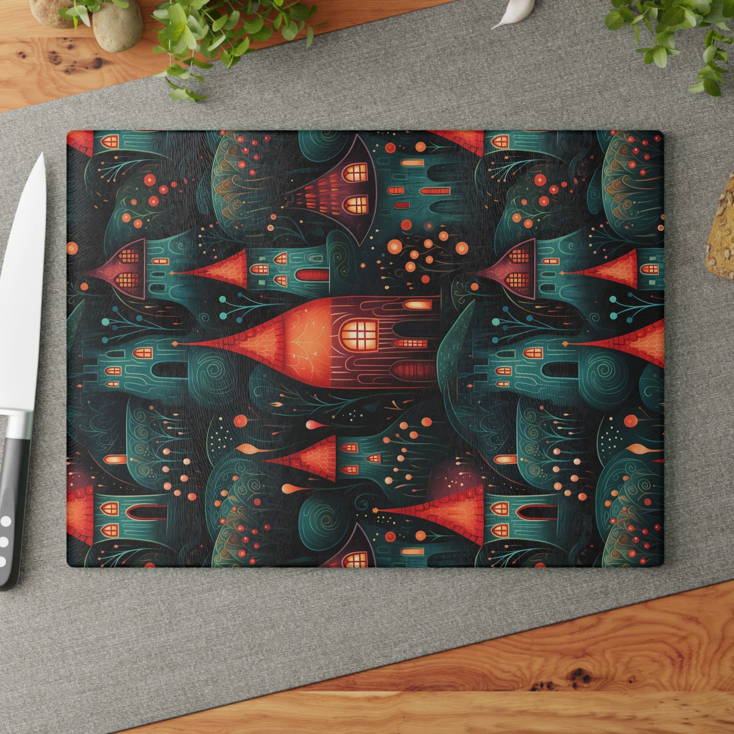 Autumn-themed glass cutting board styled on a kitchen counter with a knife and ingredients. Large size shown: 11" x 15"
