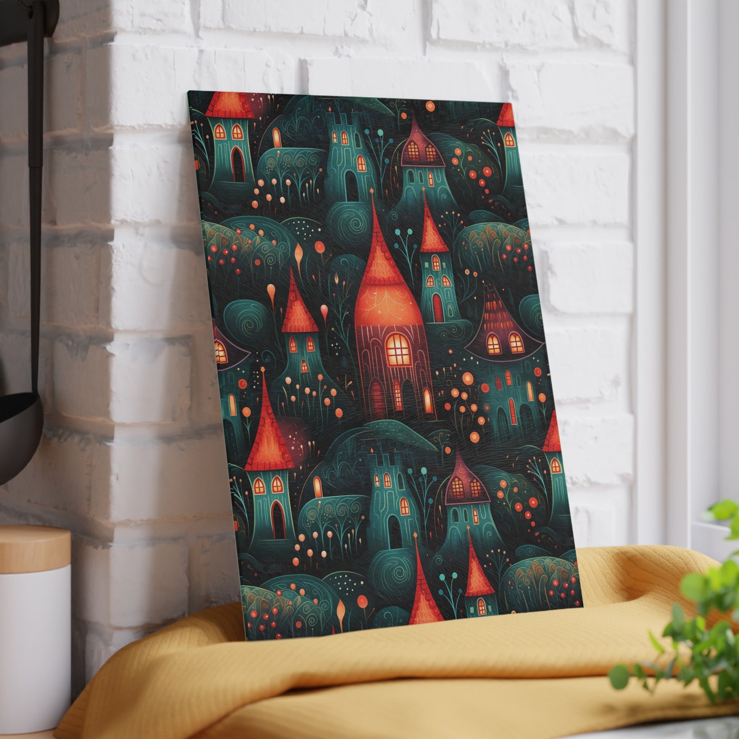 Rustic village-inspired glass cutting board propped against a white brick wall for a decorative look. Small size: 8 x 11 inches