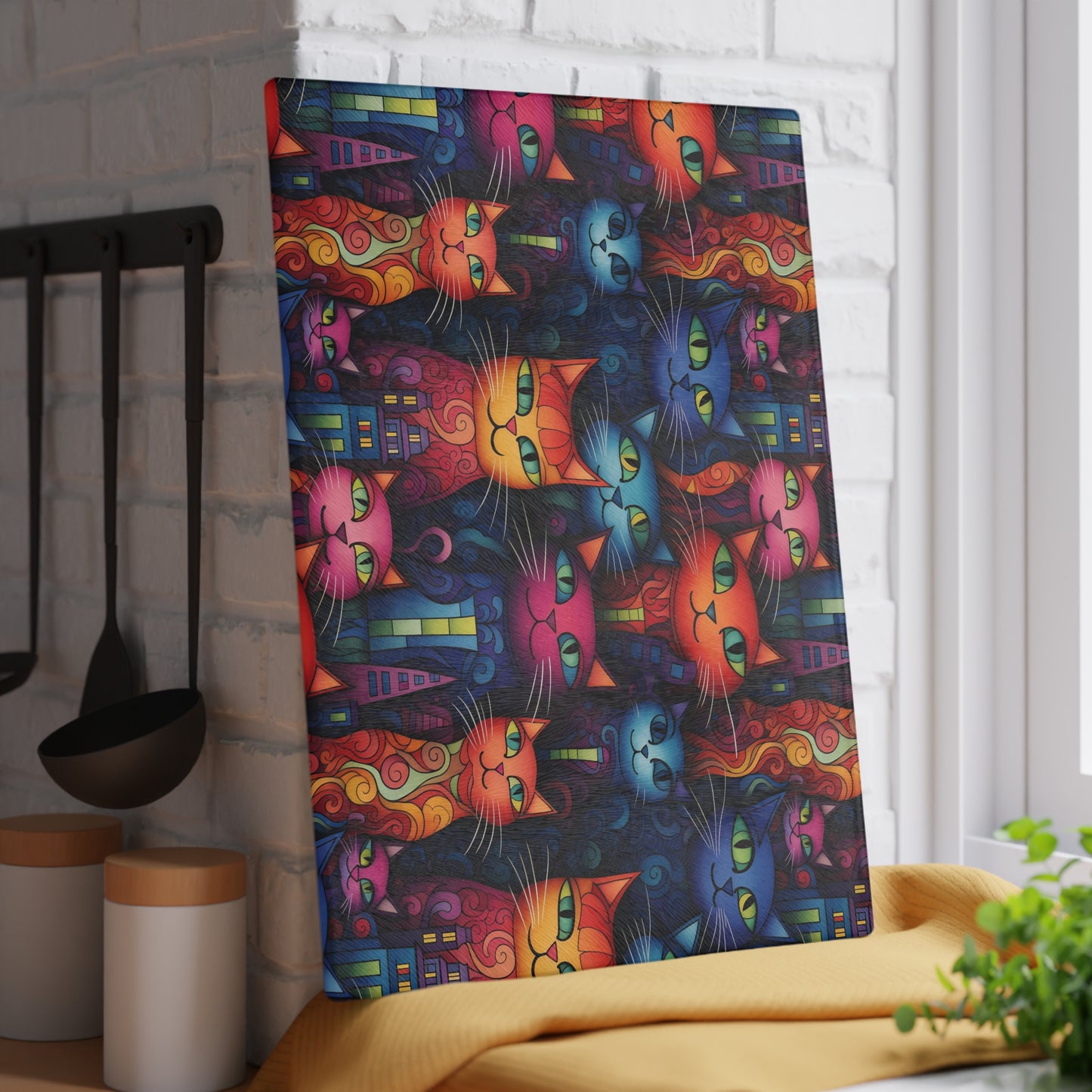 Decorative glass cutting board featuring artistic cat faces in a bold, modern city setting. Large size is 11" x 15".