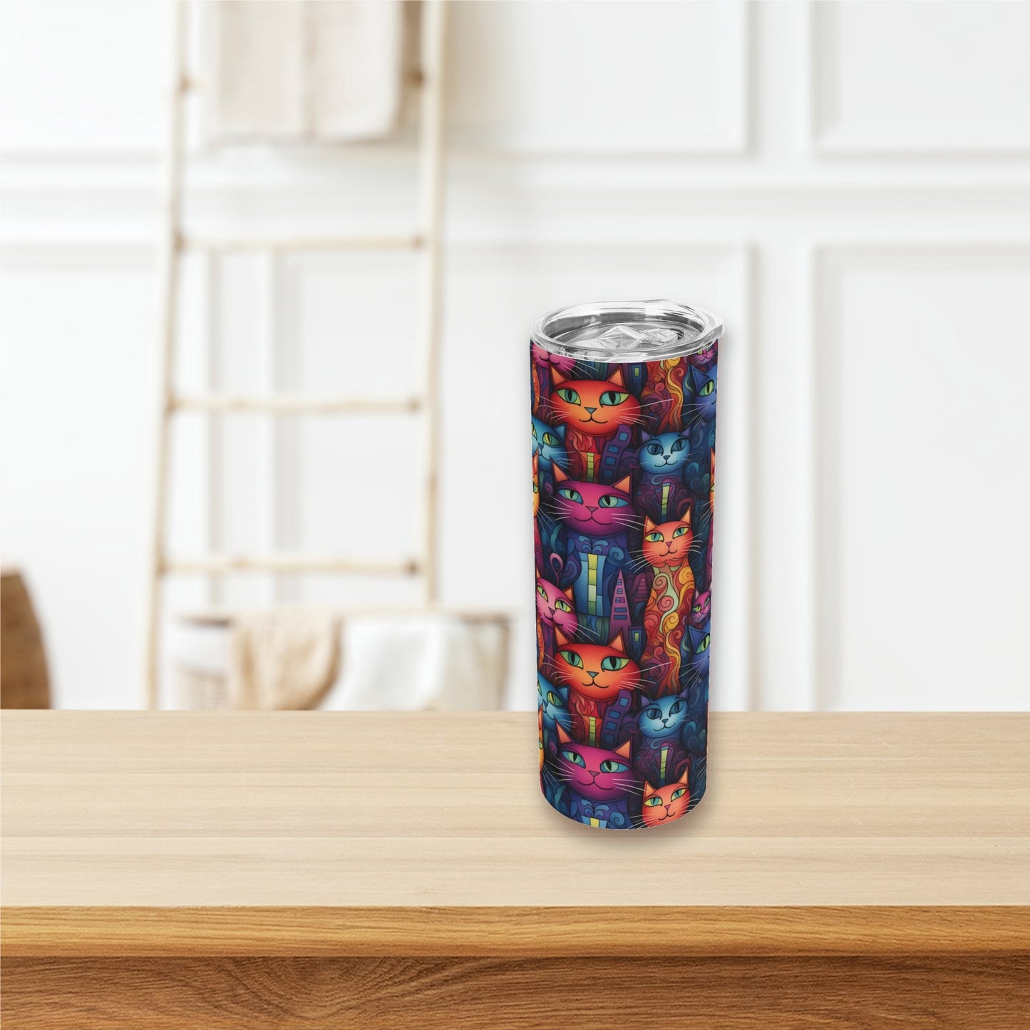 Tumbler with colorful cat pattern on a wooden surface