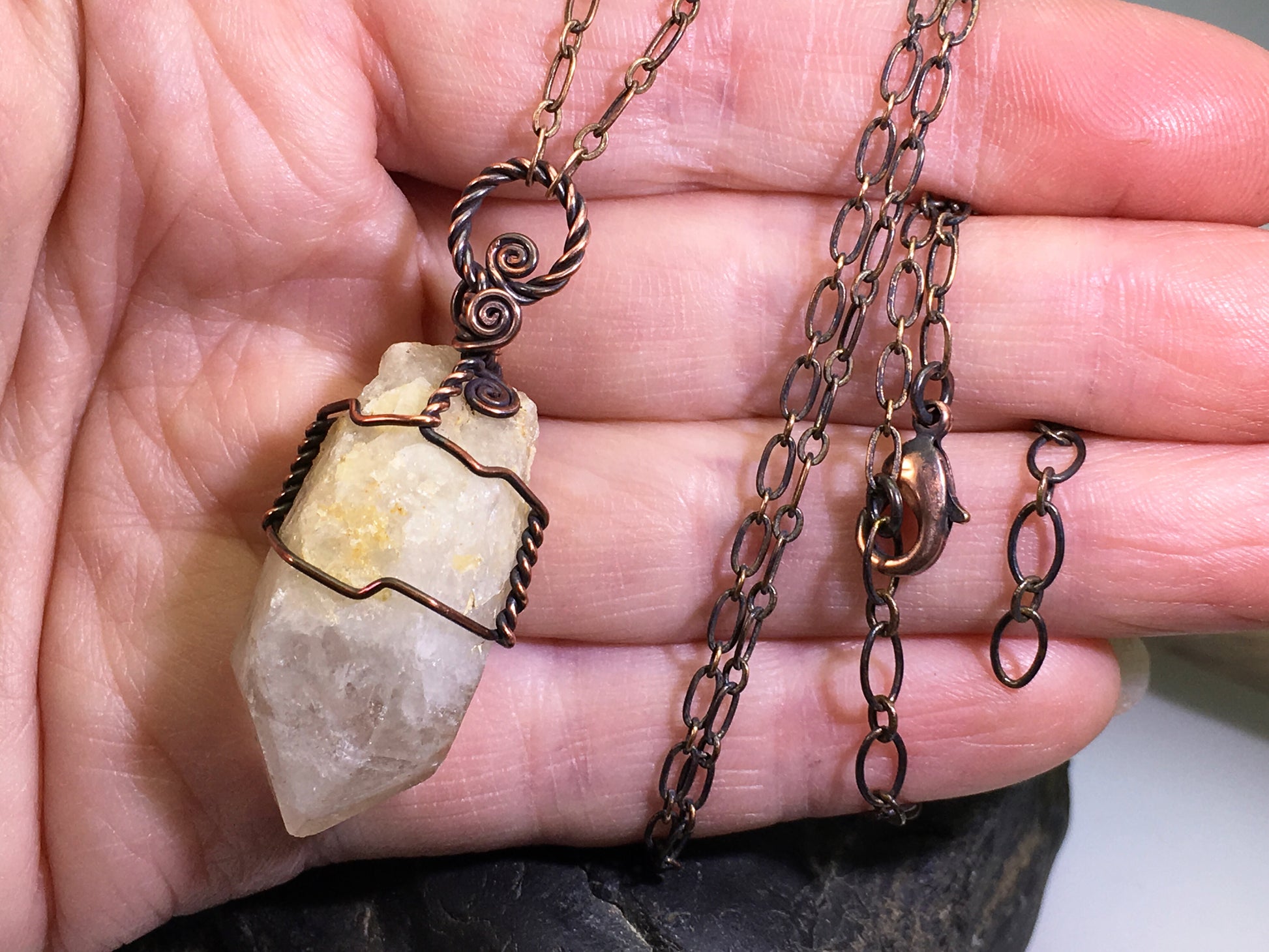 genuine natural citrine point necklace showing candle quartz growth and copper wire wrapping with adjustable chain held in hand