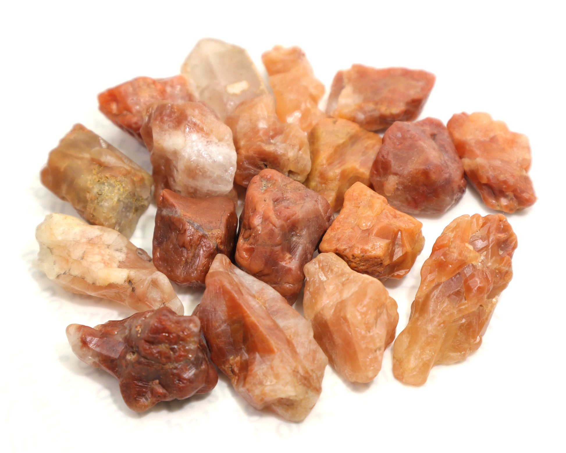 Collection of natural red phantom quartz mineral specimens in various shapes and shades