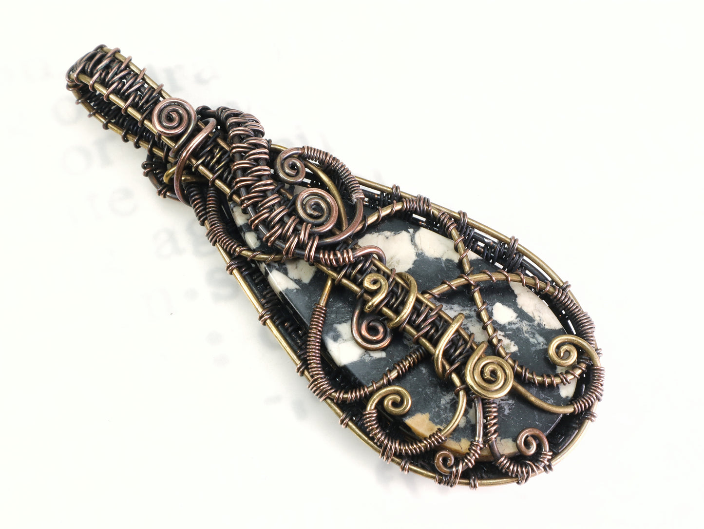 Back side of Artisan magnesite jewelry with intricate woven metalwork