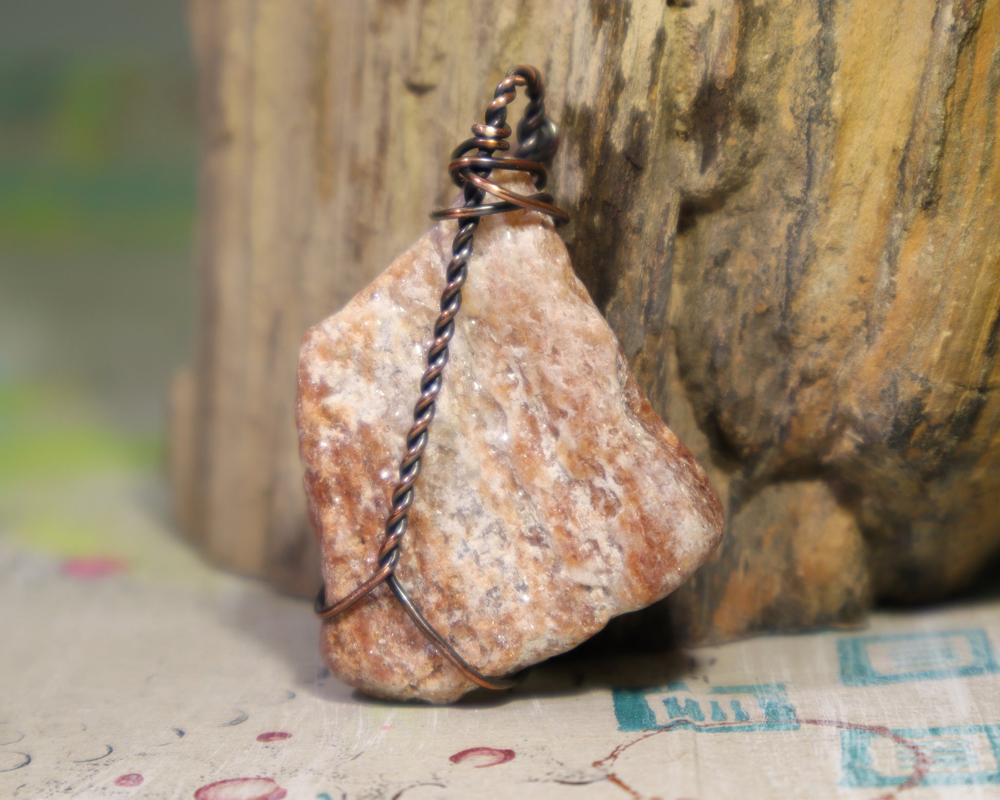 back side of one of a kind geological specimen pendant wrapped in copper wire