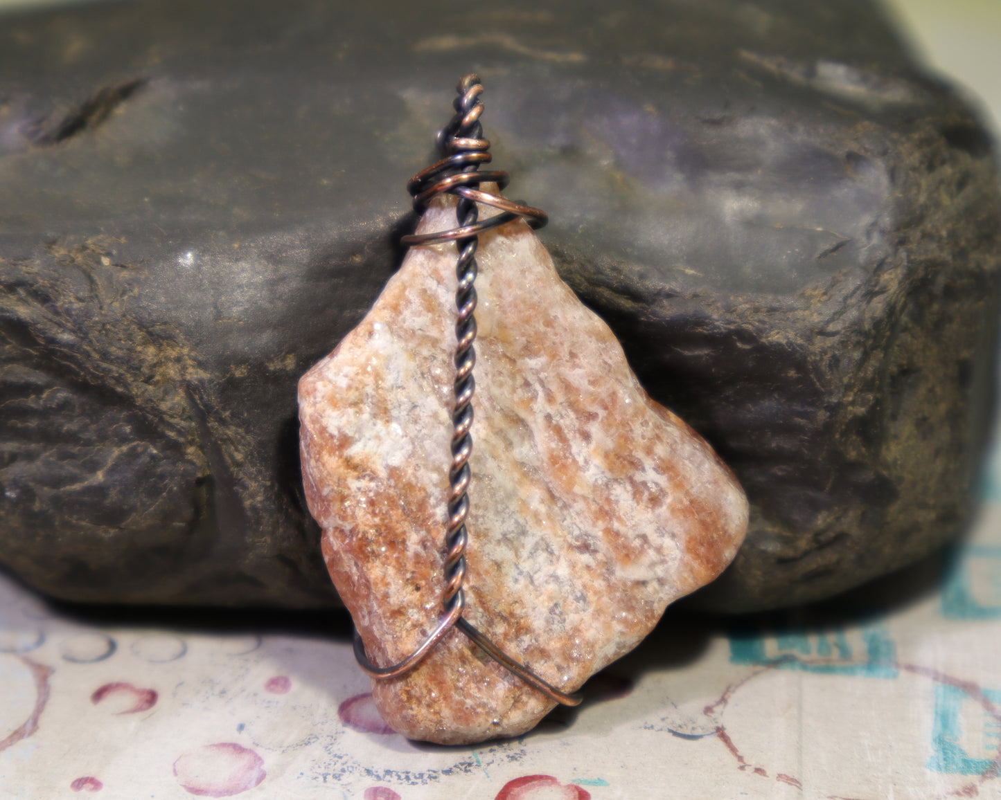 Back side of natural pegmatite rock pendant with sparkling muscovite mica crystals
