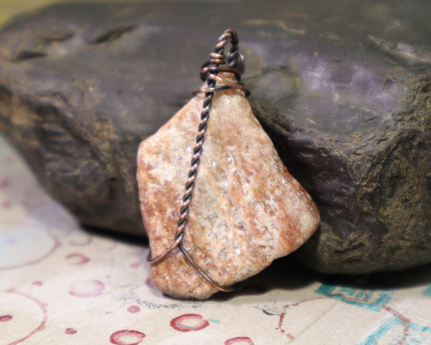 Back side of raw igneous rock pendant featuring mica rich pegmatite, perfect for rockhounds and geologists