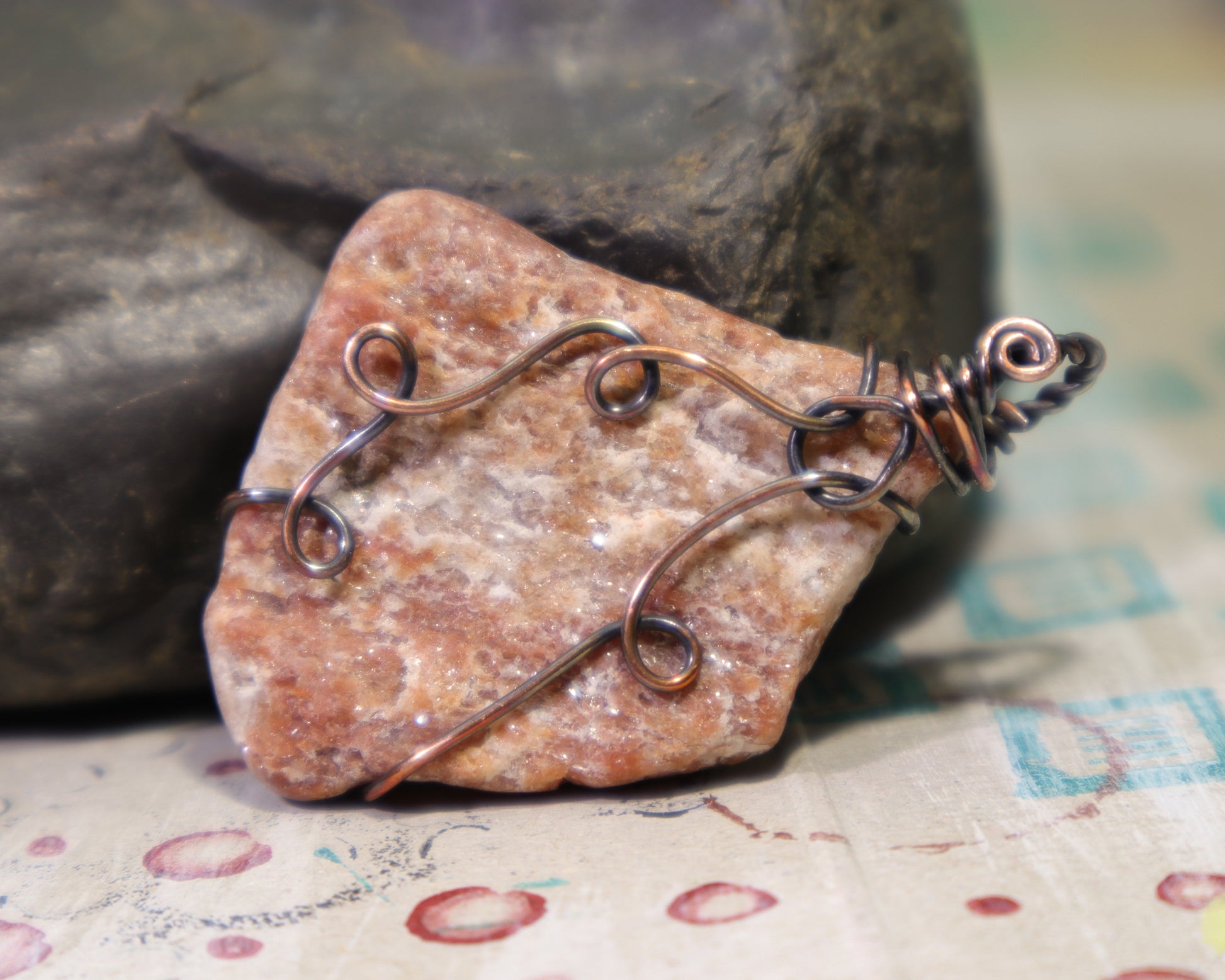 Muscovite rich pegmatite pendant wire wrapped in oxidized copper