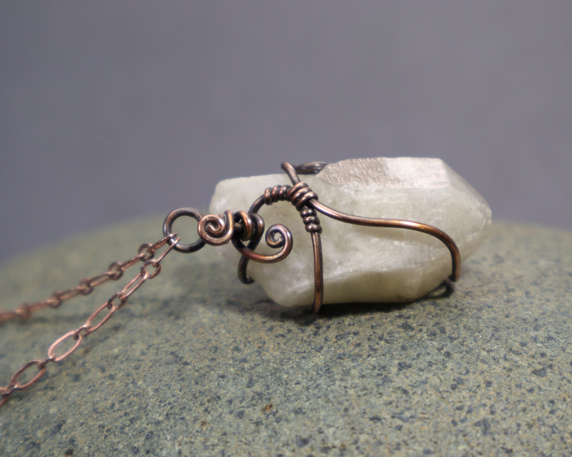 Back side of genuine unheated citrine crystal point necklace in oxidized copper