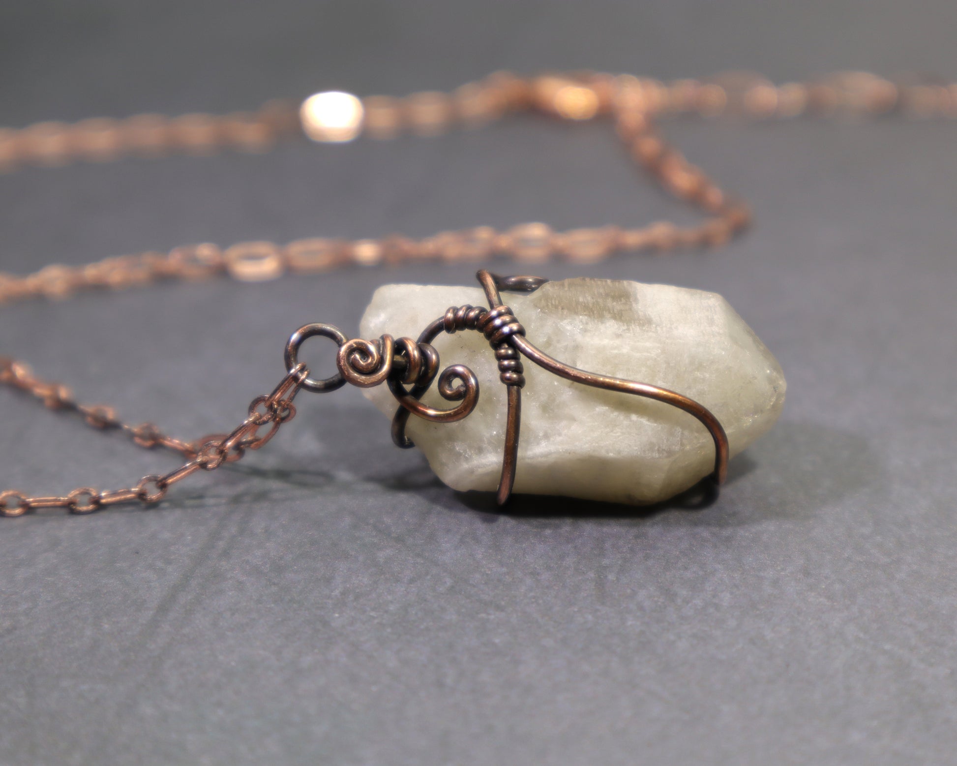 Back side of raw natural citrine crystal pendant wire wrapped in oxidized copper with adjustable copper chain