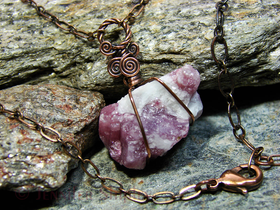 Raw pink tourmaline pendant necklace with natural rubellite crystals in white albite matrix wire wrapped in antiqued copper with an adjustable chain