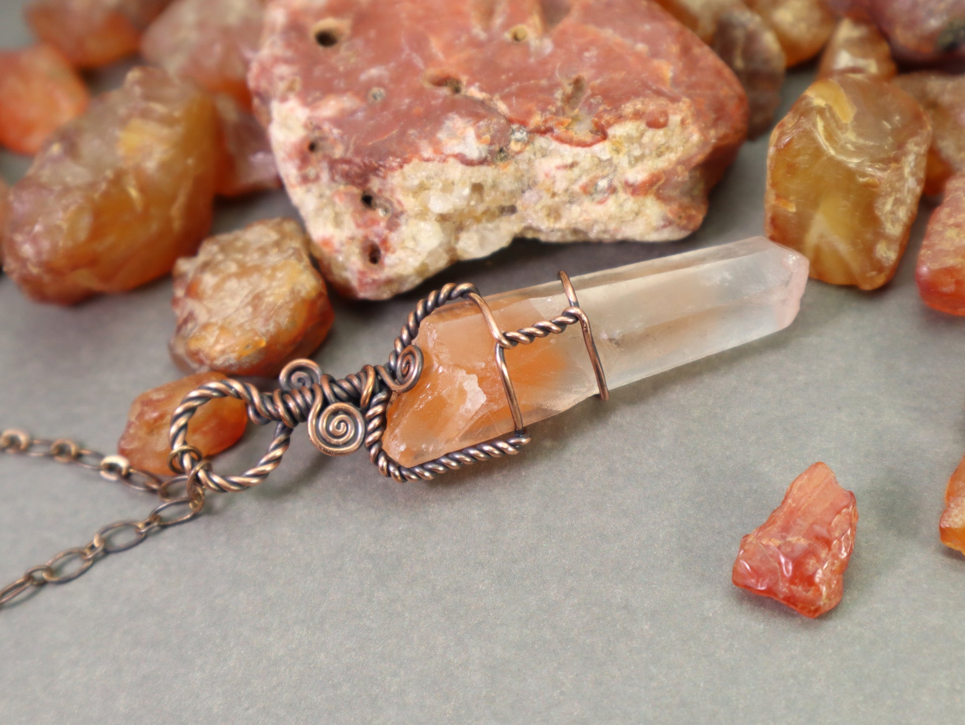 One of a kind red phantom quartz crystal necklace handmade in Washington, shown photographed with raw washington state carnelian rockhounded by the artist.