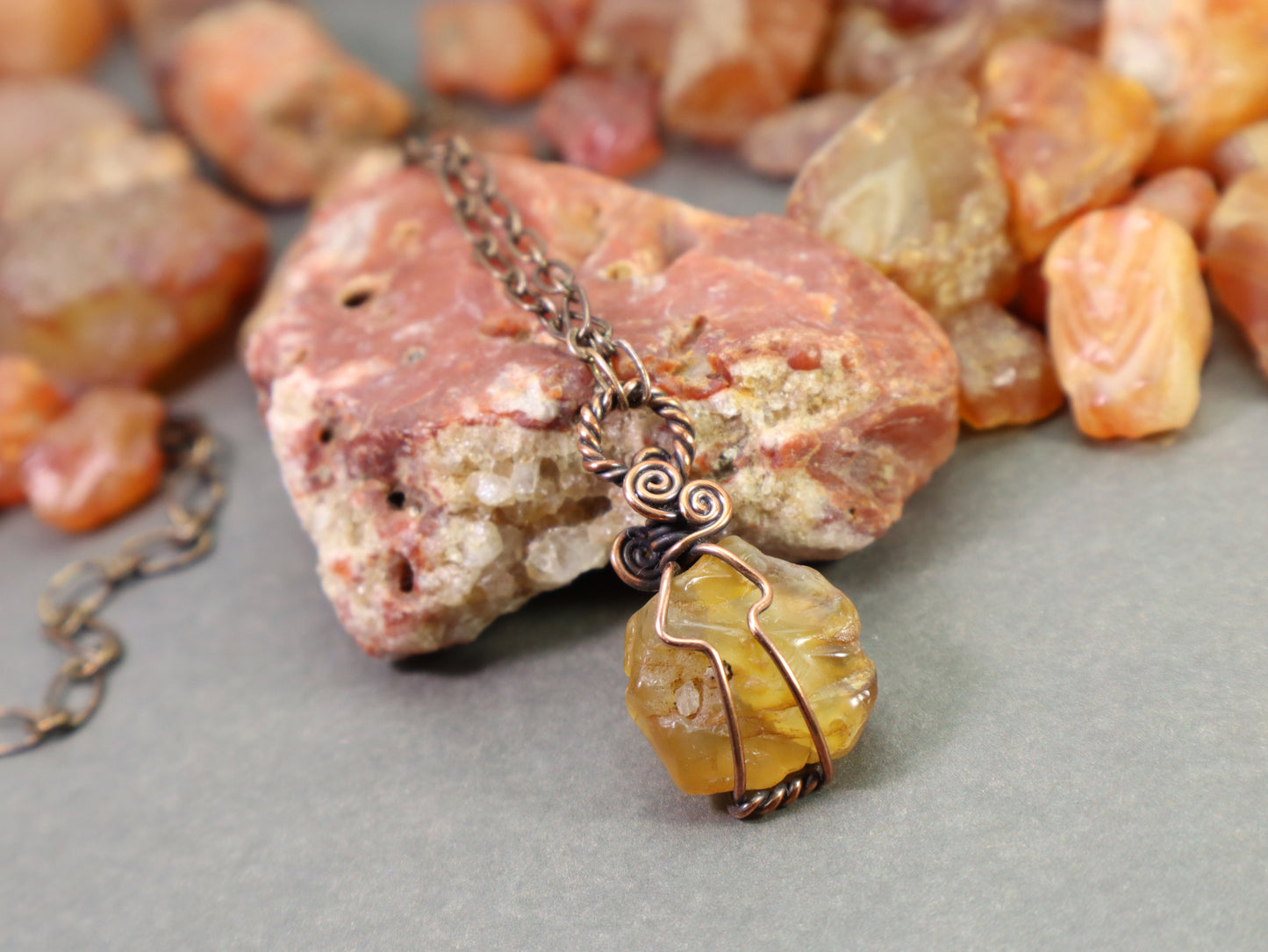 Natural yellow orange carnelian agate crystal pendant close up detail