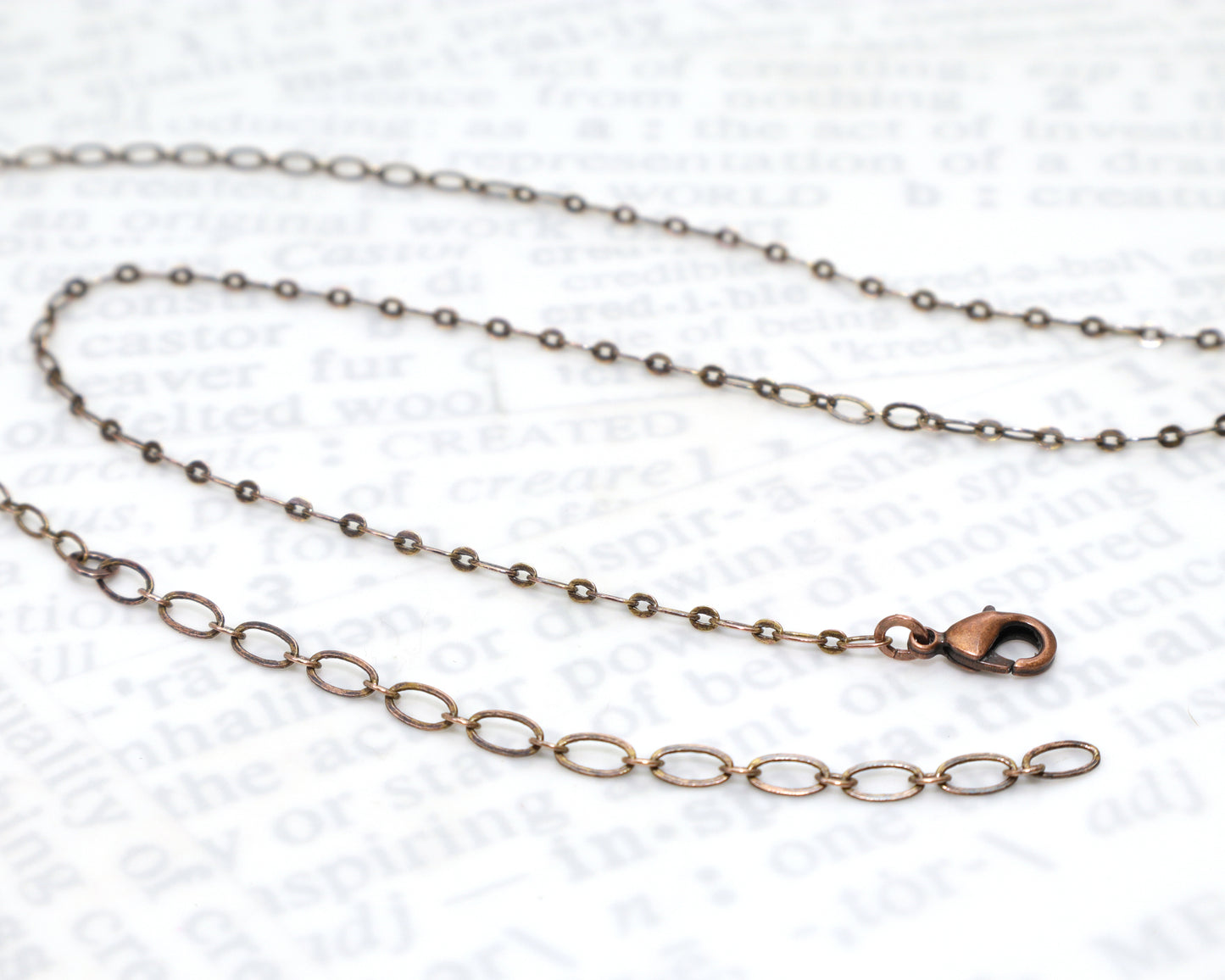 Antiqued copper flat link cable chain with a lobster clasp and a 3 inch extender chain.