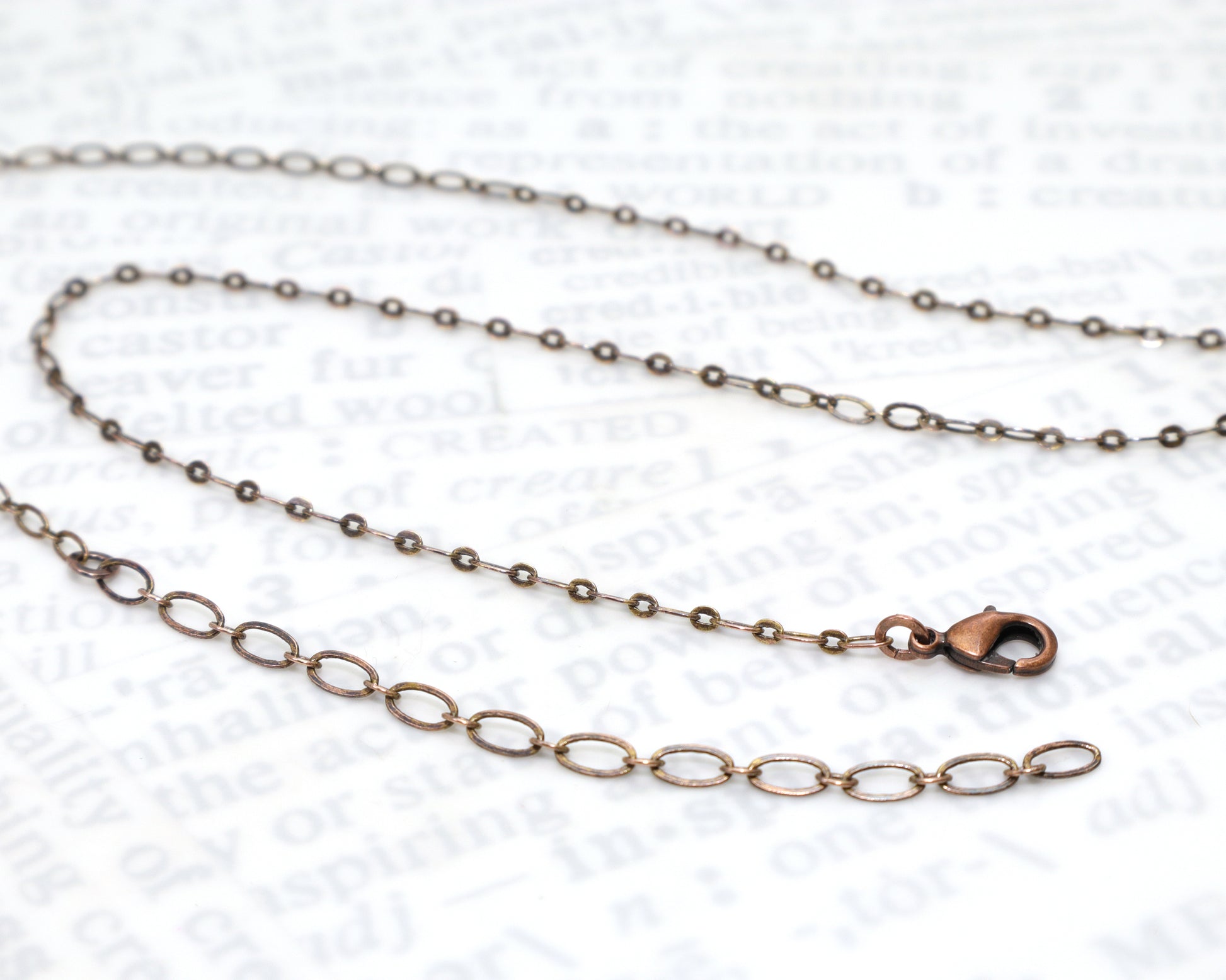 Antiqued copper flat link cable chain with a lobster clasp and a 3 inch extender chain.