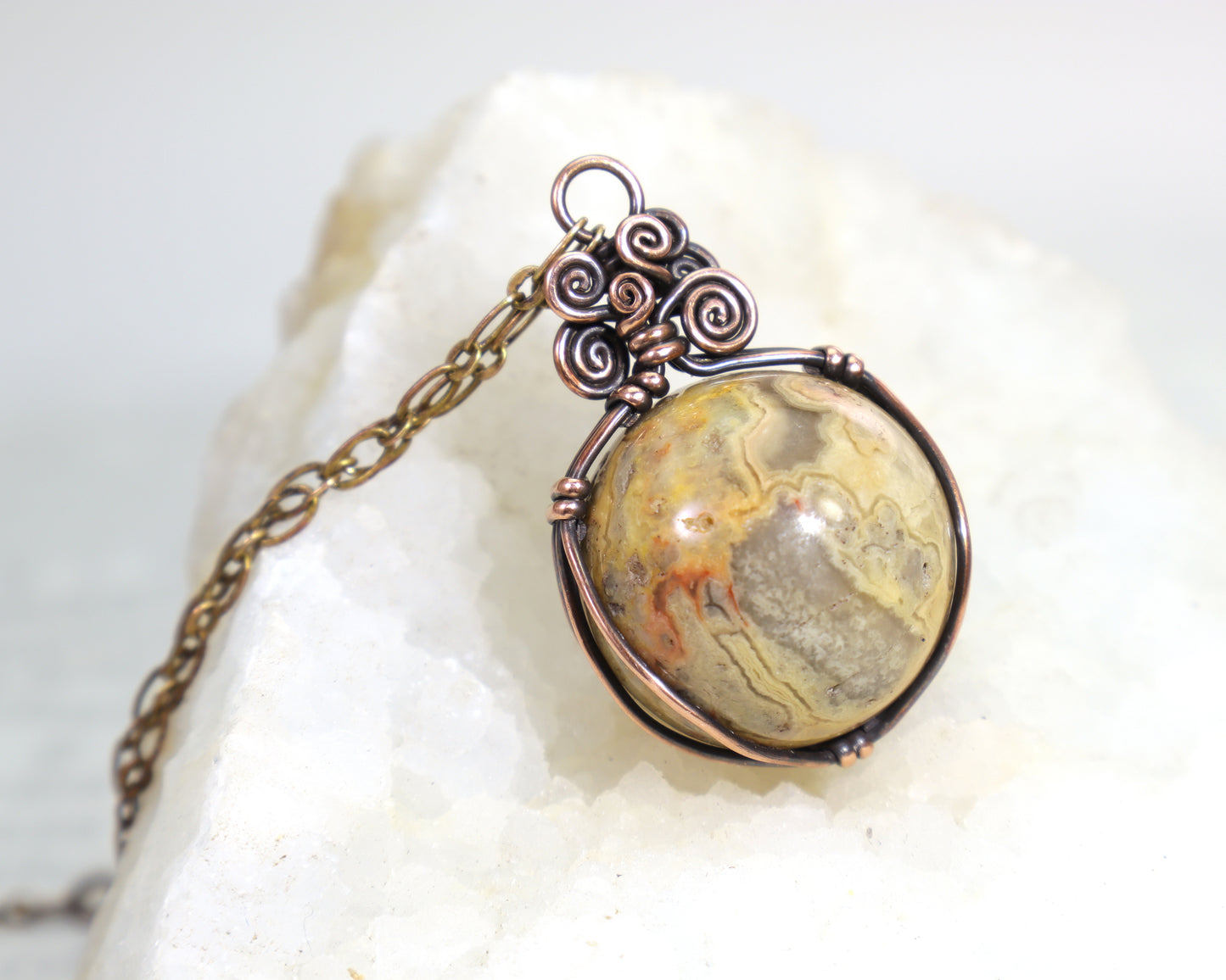 Handmade copper necklace featuring natural crazy lace agate sphere