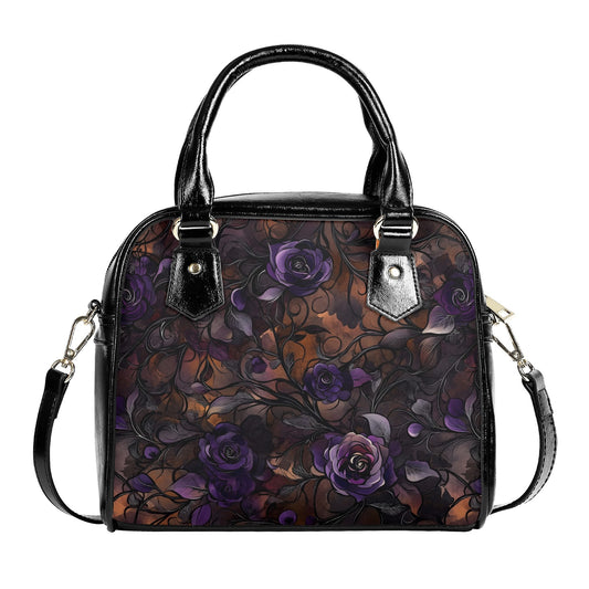A floral pattern handbag with rich purple roses and autumnal hues, featuring a leather crossbody strap and handles.
