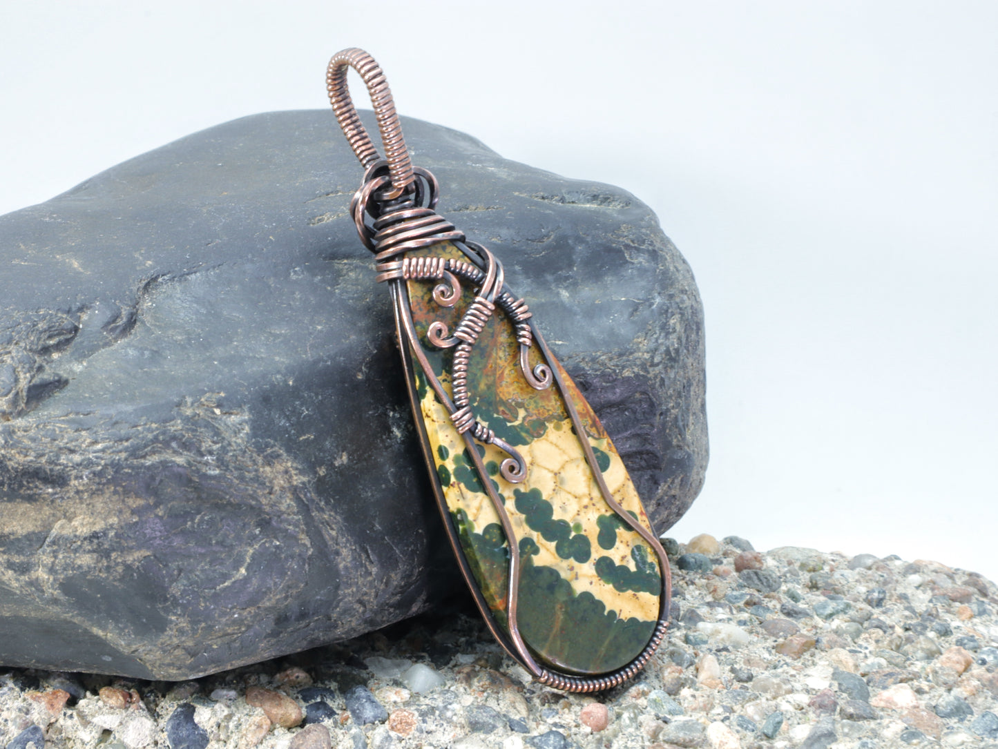 Back side of unique orbicular jasper jewelry with landscape-like patterns