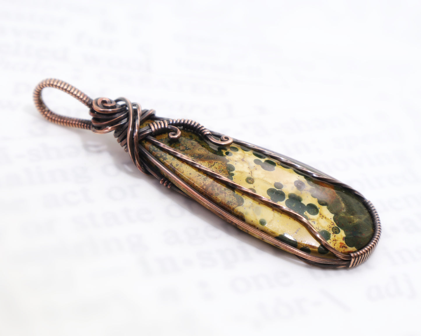 Unique orbicular jasper jewelry with landscape-like patterns on a white background