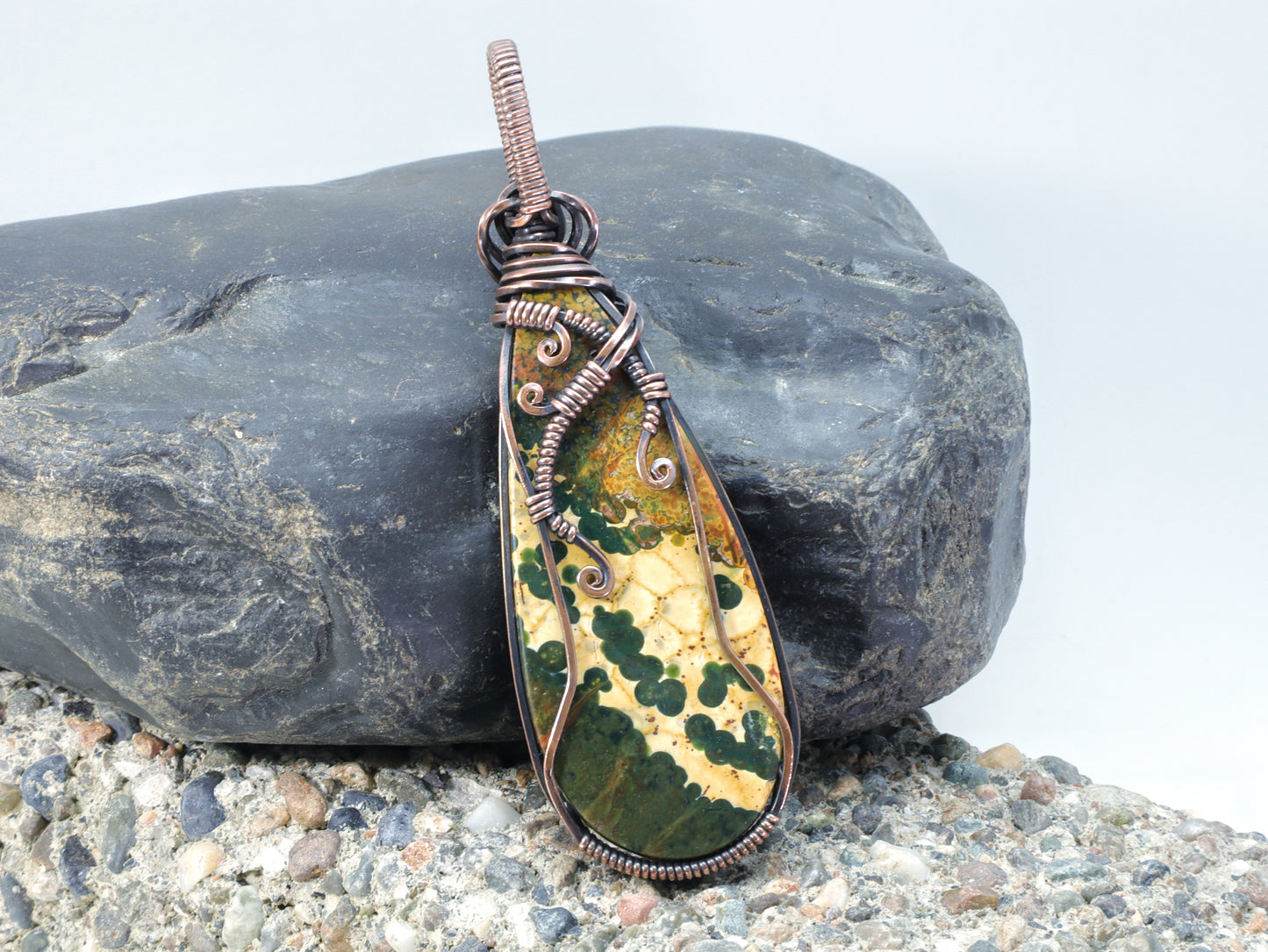 Back side of Handmade Ocean Jasper jewelry featuring colorful orb patterns