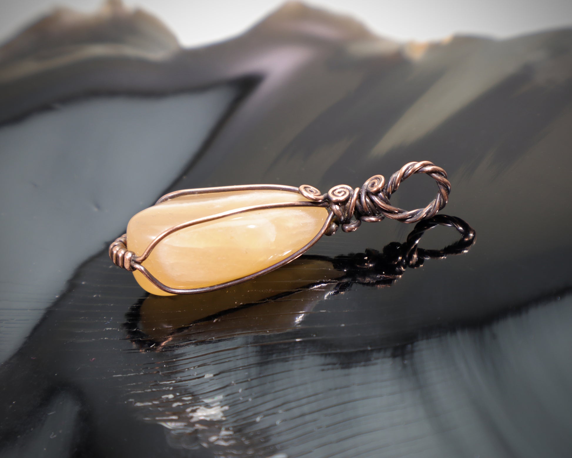 Handmade peach moonstone crystal pendant with copper wire wrap