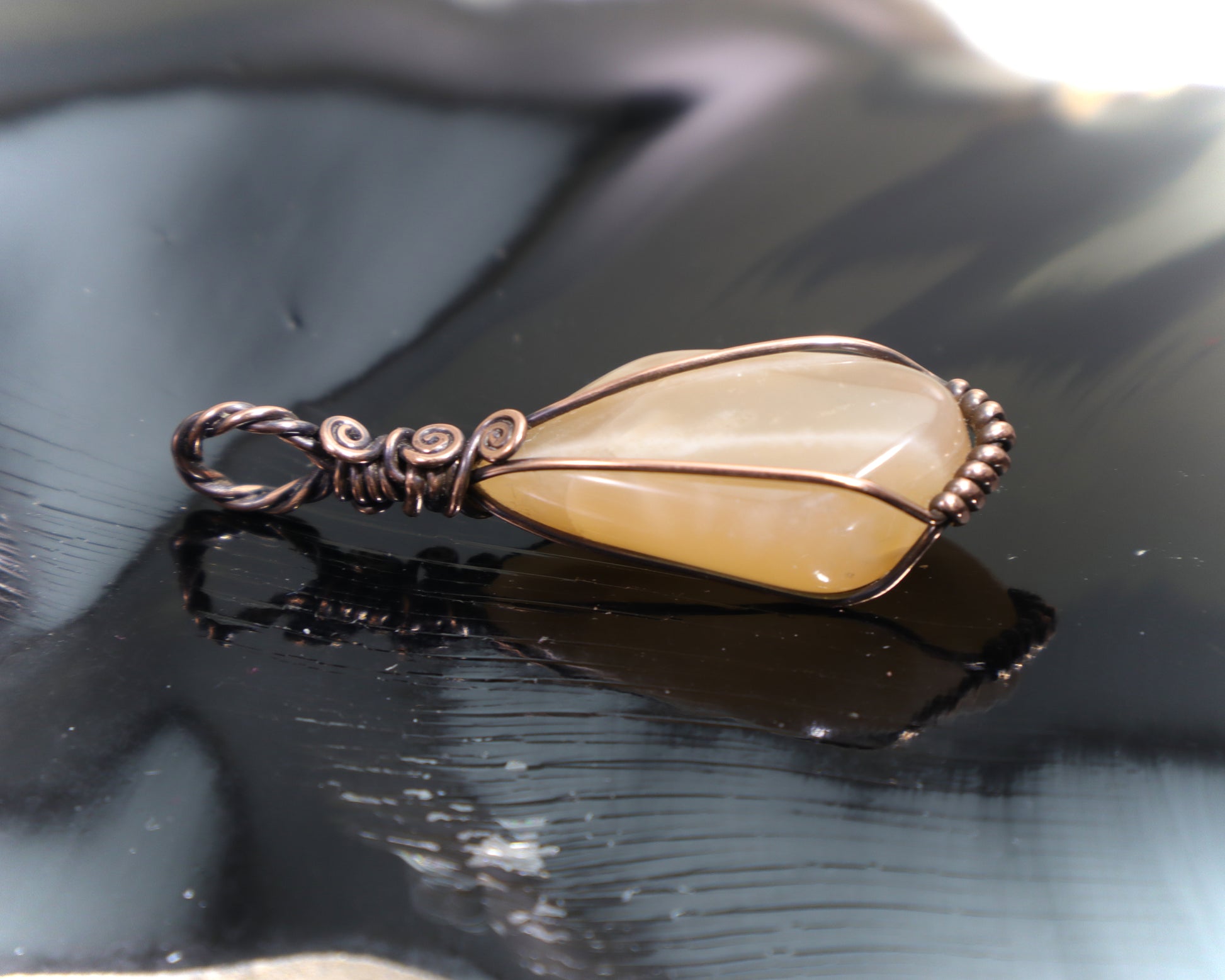 Natural peach moonstone gemstone pendant showing soft adularescence