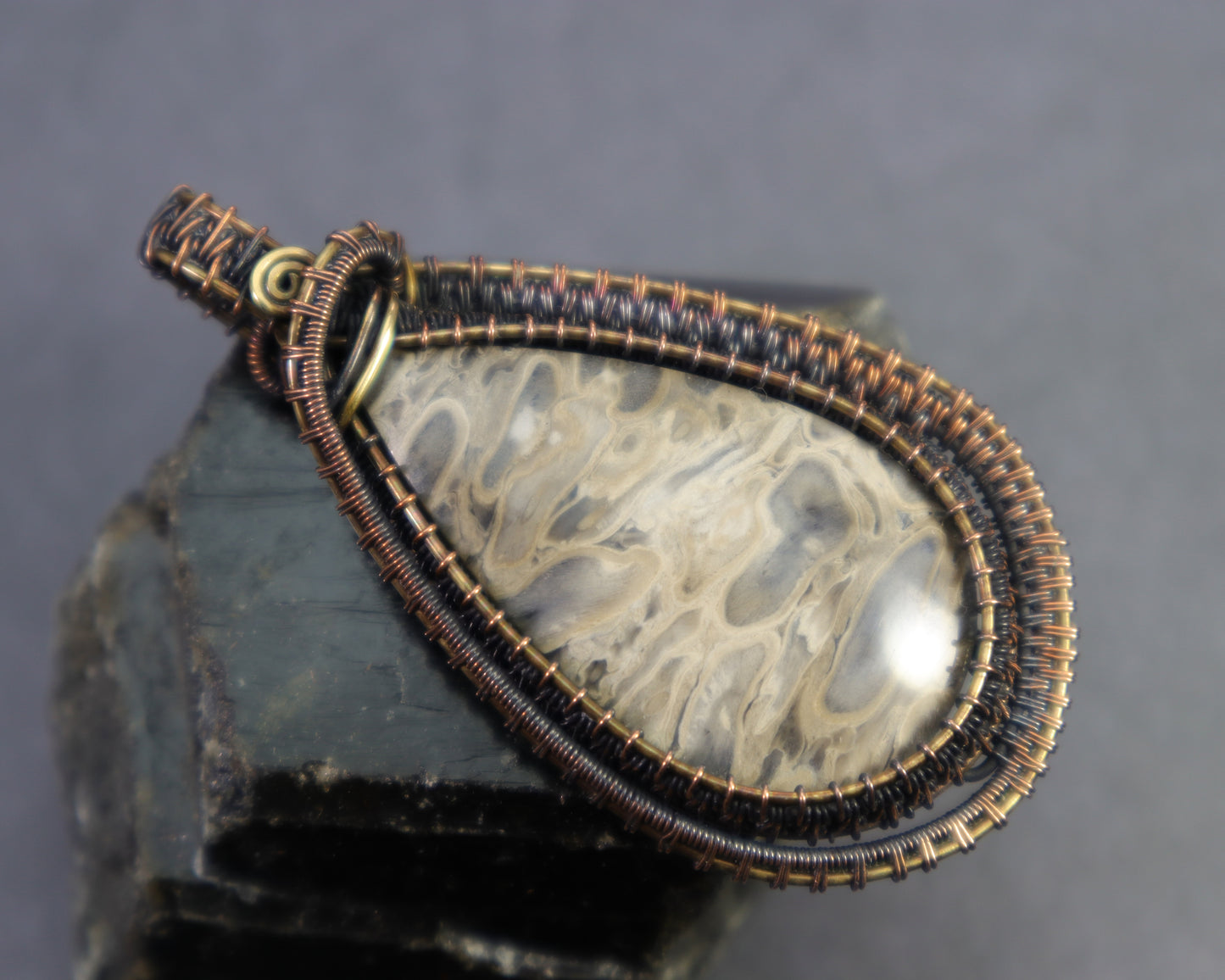 Handmade petrified palmwood gemstone pendant with intricate wire weaving