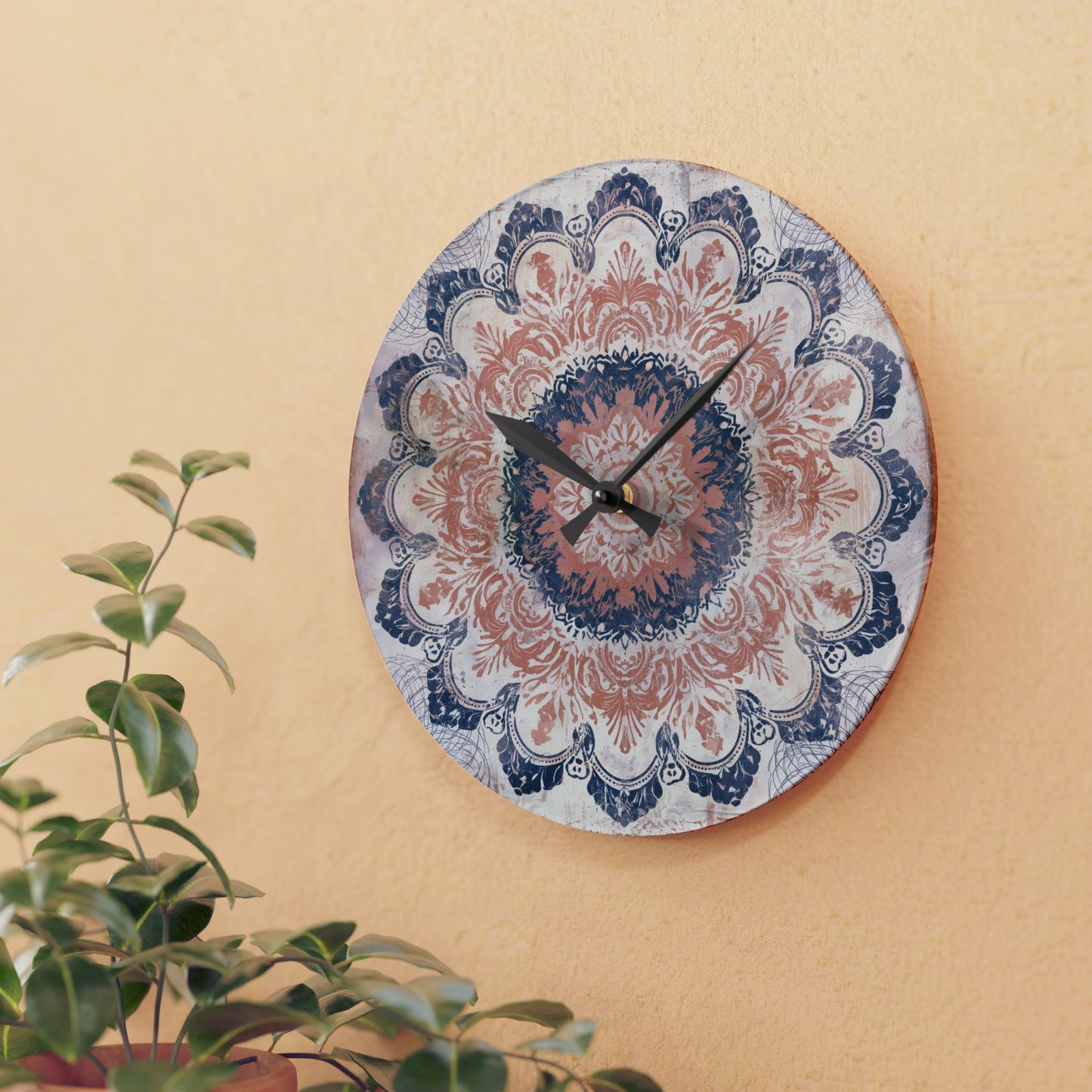 Round decorative mandala wall clock displayed on beige wall with green houseplant