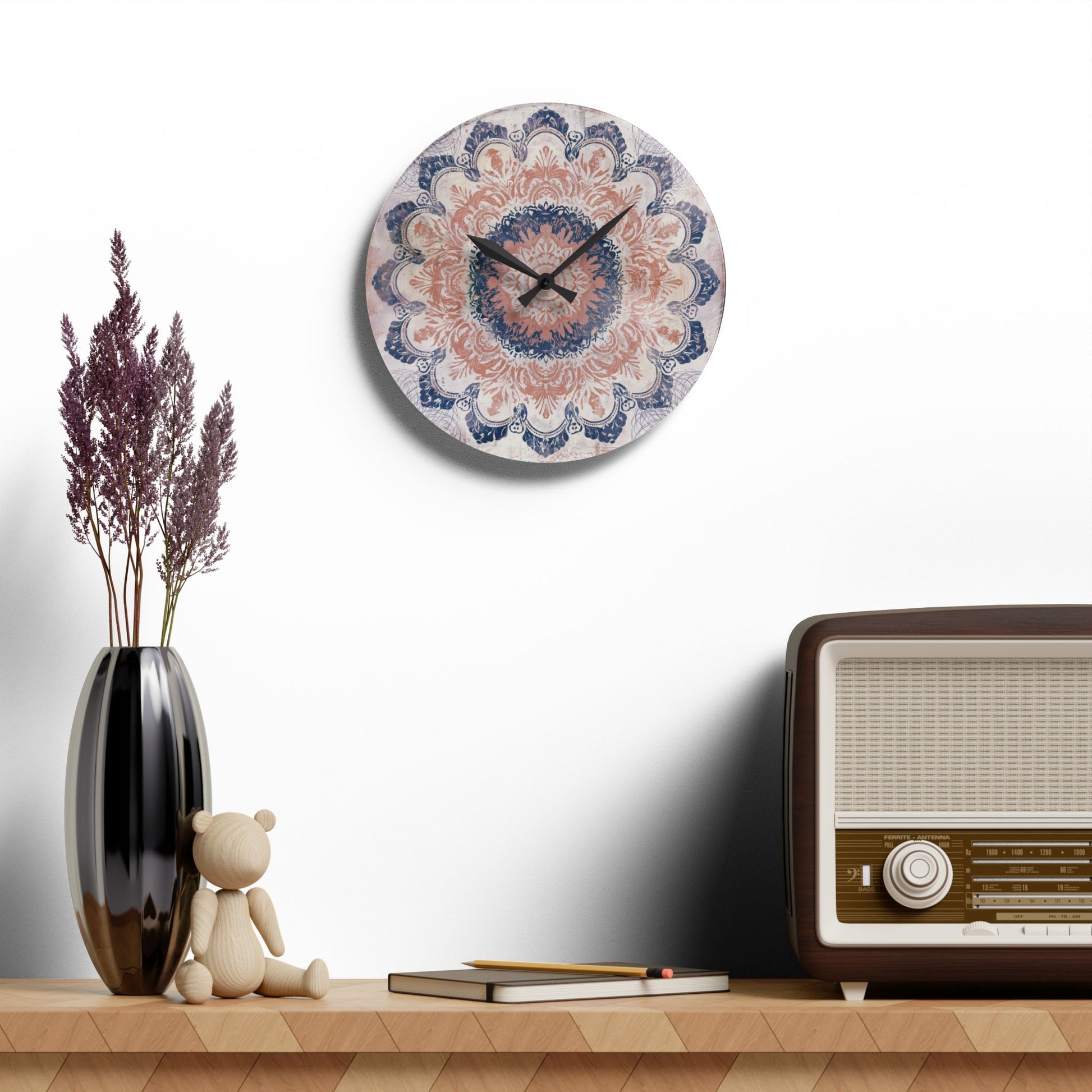 Round acrylic wall clock with boho mandala artwork displayed above shelf decor and vintage radio