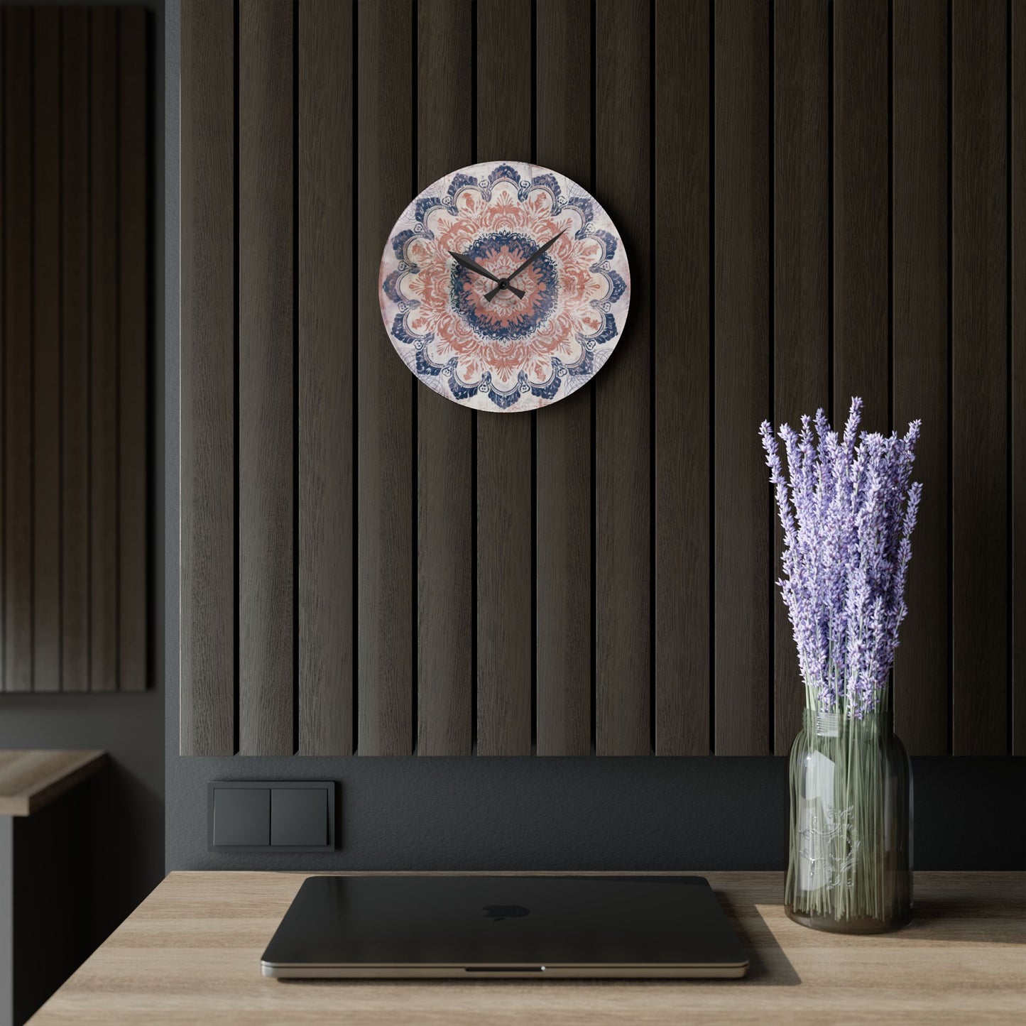 Round rose pink and navy blue mandala wall clock hanging on dark modern wood wall