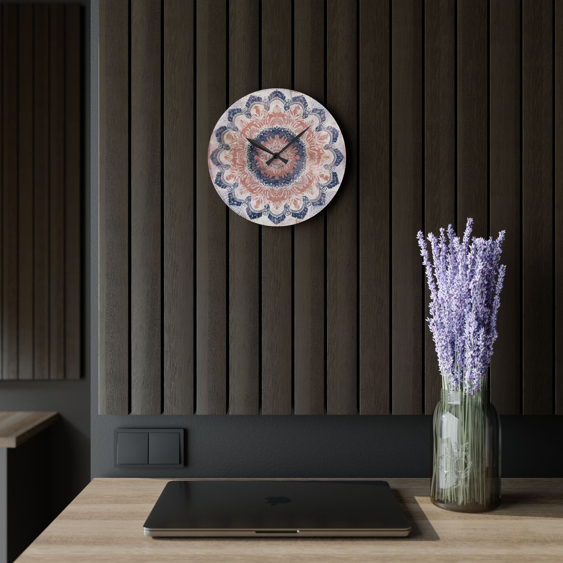 Round rose pink and navy blue mandala wall clock hanging on dark modern wood wall