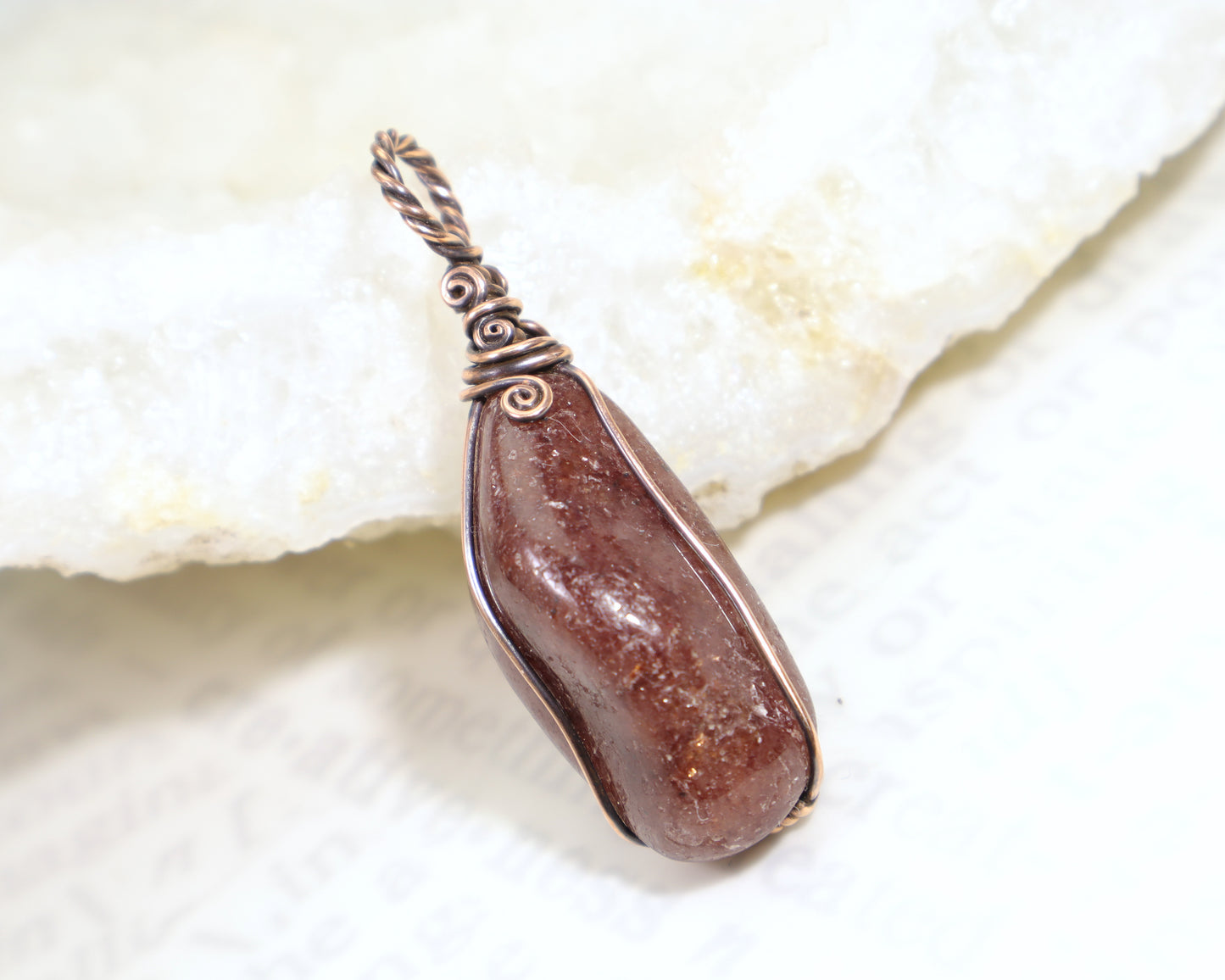 Natural red aventurine gemstone pendant with oxidized copper wire wrap
