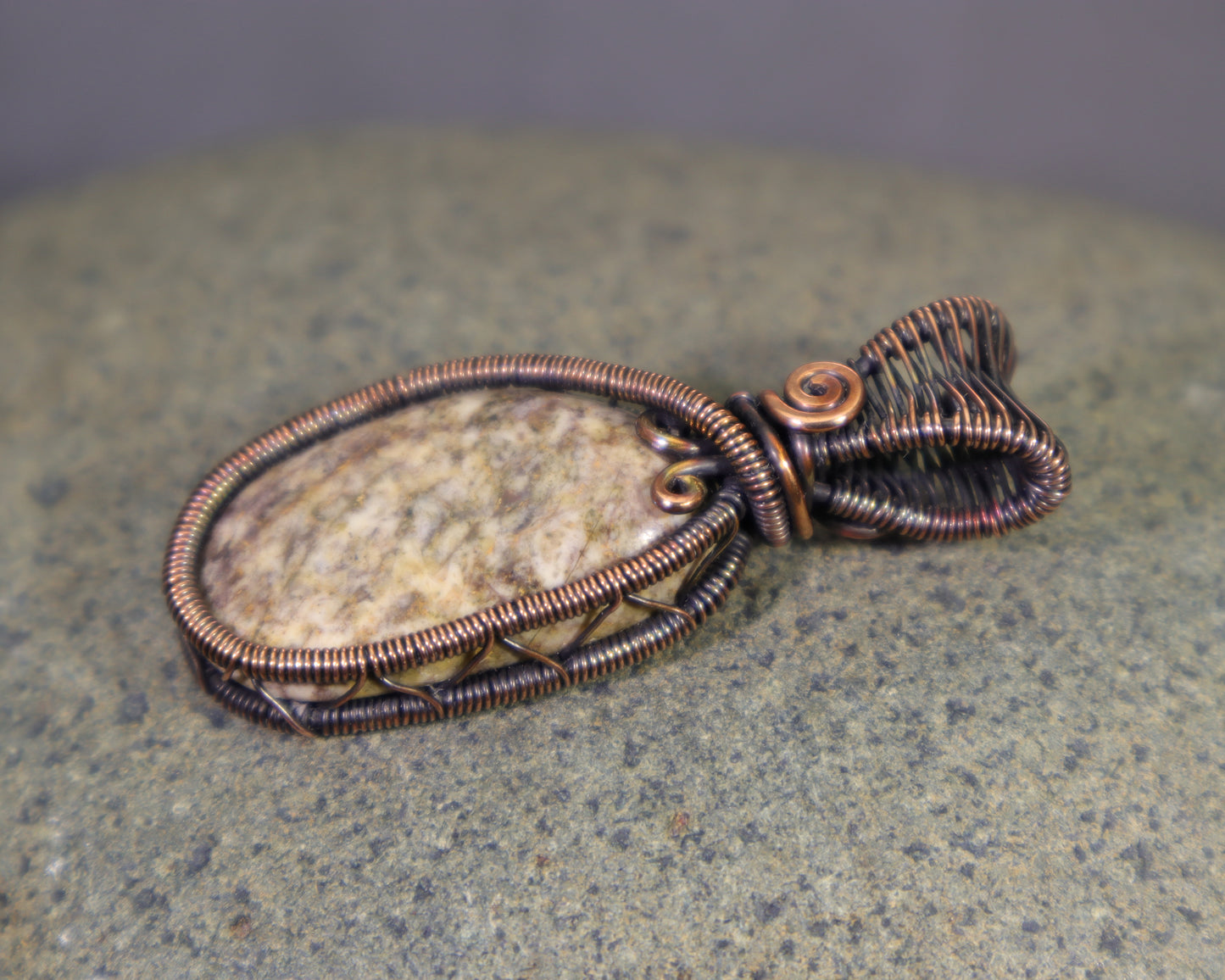 Copper wire weave pendant showcasing a natural jasper cabochon