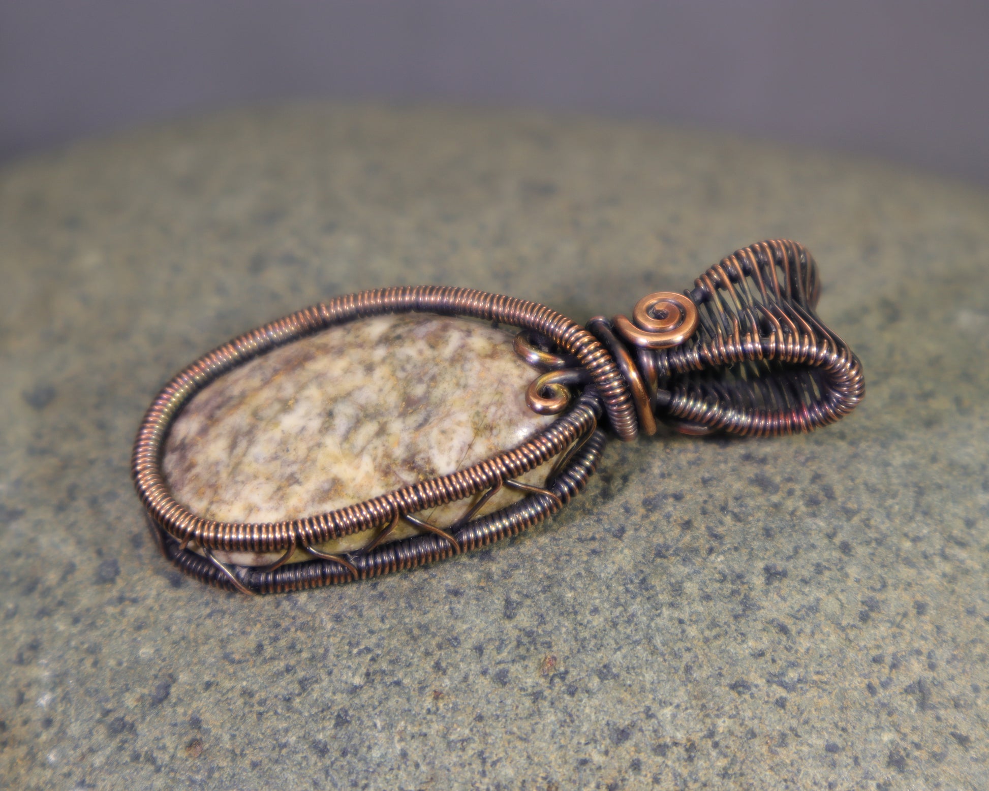 Copper wire weave pendant showcasing a natural jasper cabochon