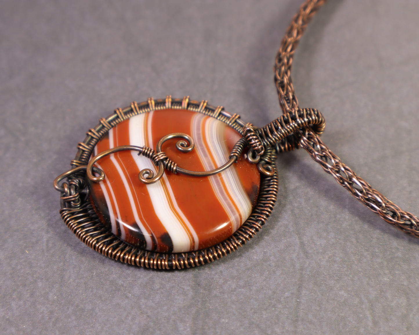 Copper wire woven sardonyx pendant with natural orange banding