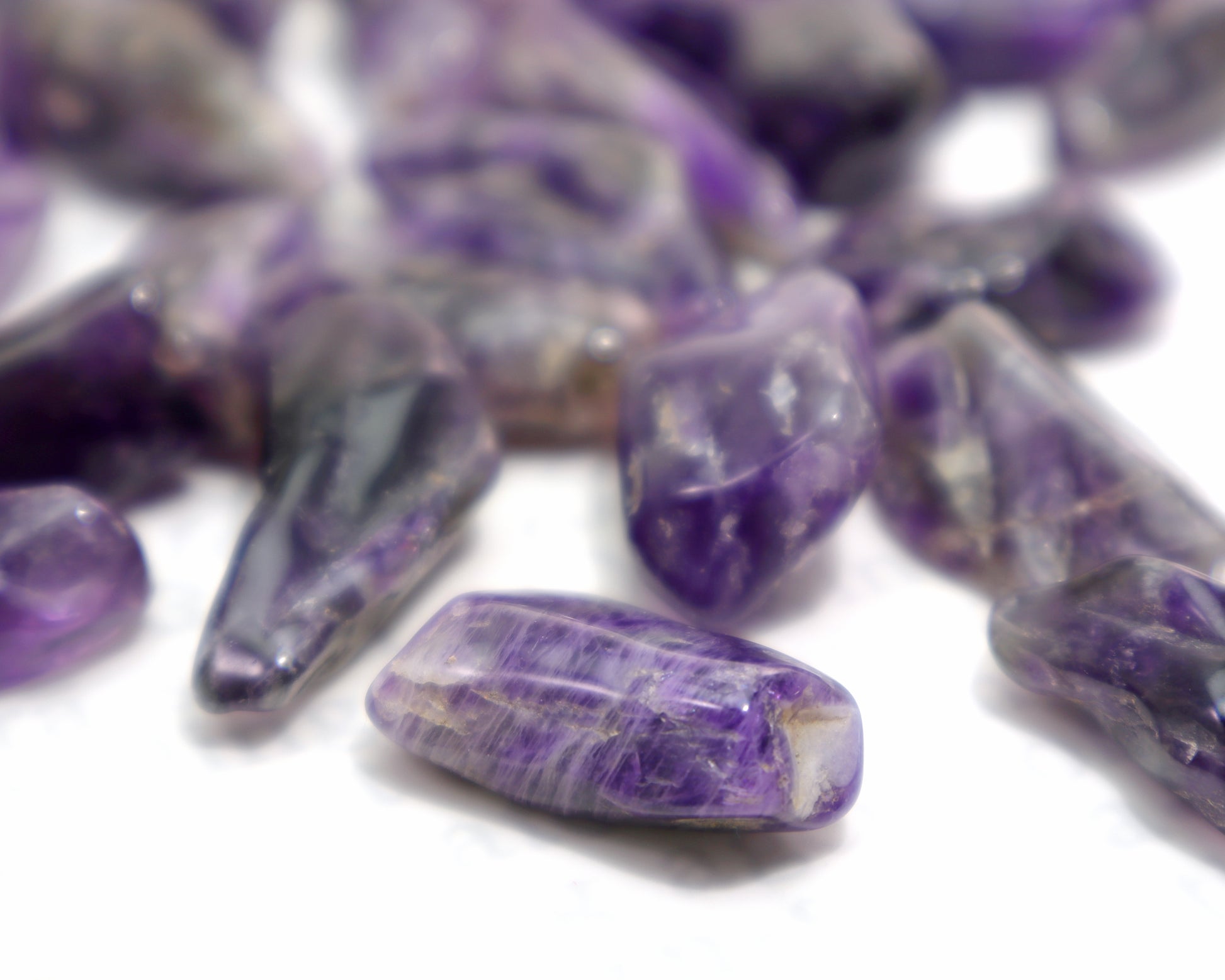 Close-up of dark purple amethyst pocket stones polished