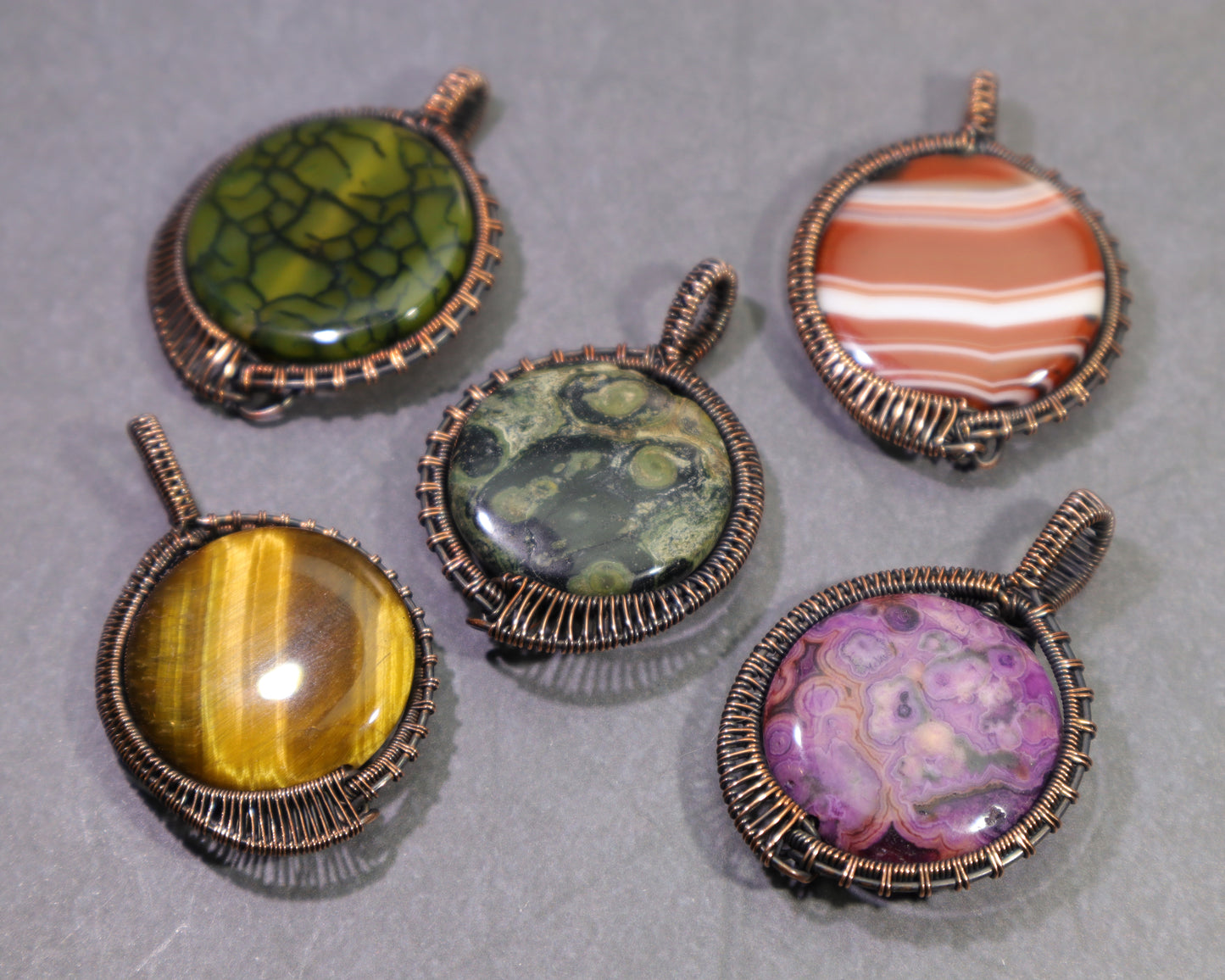 Handmade copper gemstone jewelry featuring dragon vein agate, sardonyx, crazy lace agate, tiger eye and kambaba jasper.