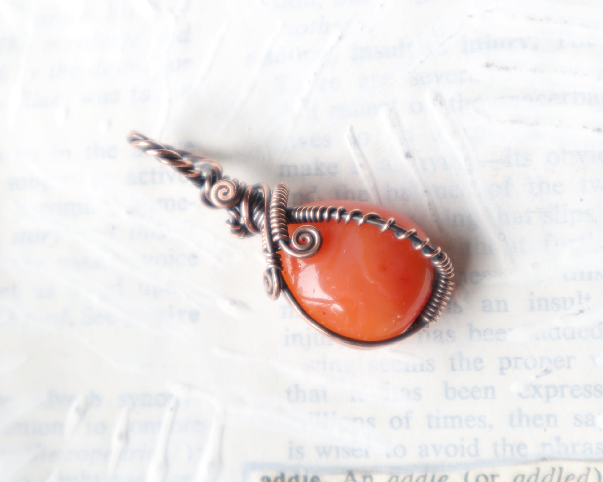 Handmade carnelian pendant wrapped in antiqued copper wire